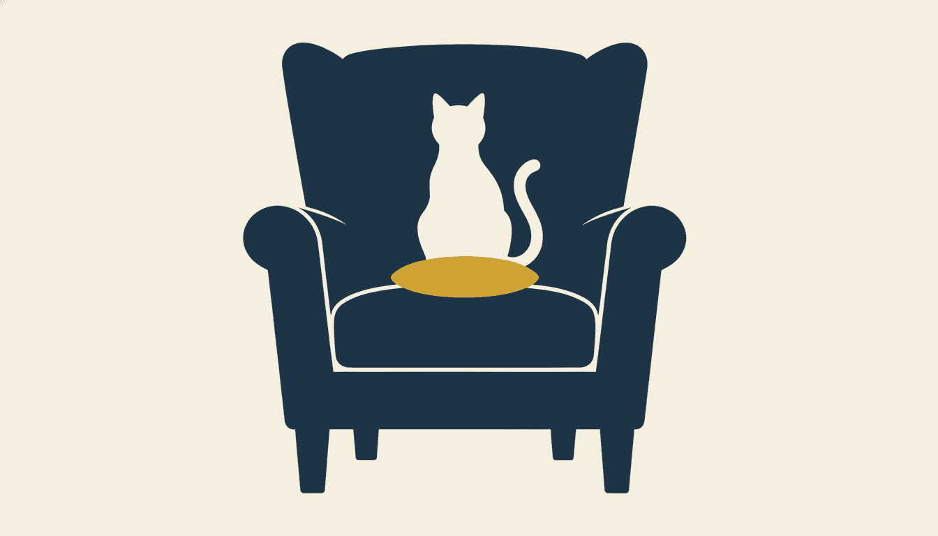 A single large solid deep navy armchair seen from the front on a flat cream ground, drawn as one unbroken shape with a tall padded back, two round arms and short legs and no texture or shading anywhere, with a clean cream cat-shaped hole cut through the middle of its back — a cat sitting upright with a round head, two pointed ears and a long tail curling up behind it — and one small oval mustard yellow cushion on the seat, the only colour in the picture besides navy and cream